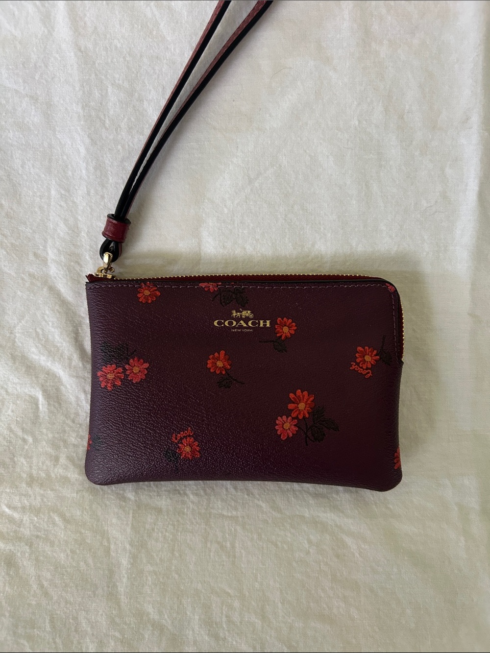 COACH Wine Floral Leather Wristlet with Gold Logo
